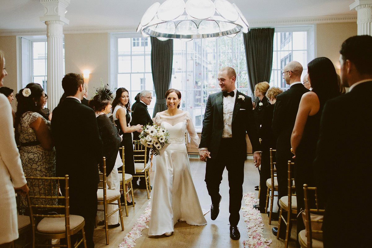 Antonietta wore a chic and elegant long sleeved Suzanne Neville gown for her black tie winter wedding at the RSA in London.