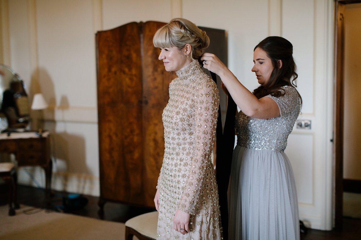 A bride in a gold, embellished Temperley London dress for her wedding at Rowallan Castle in Scotland. Images by Caro Weiss.
