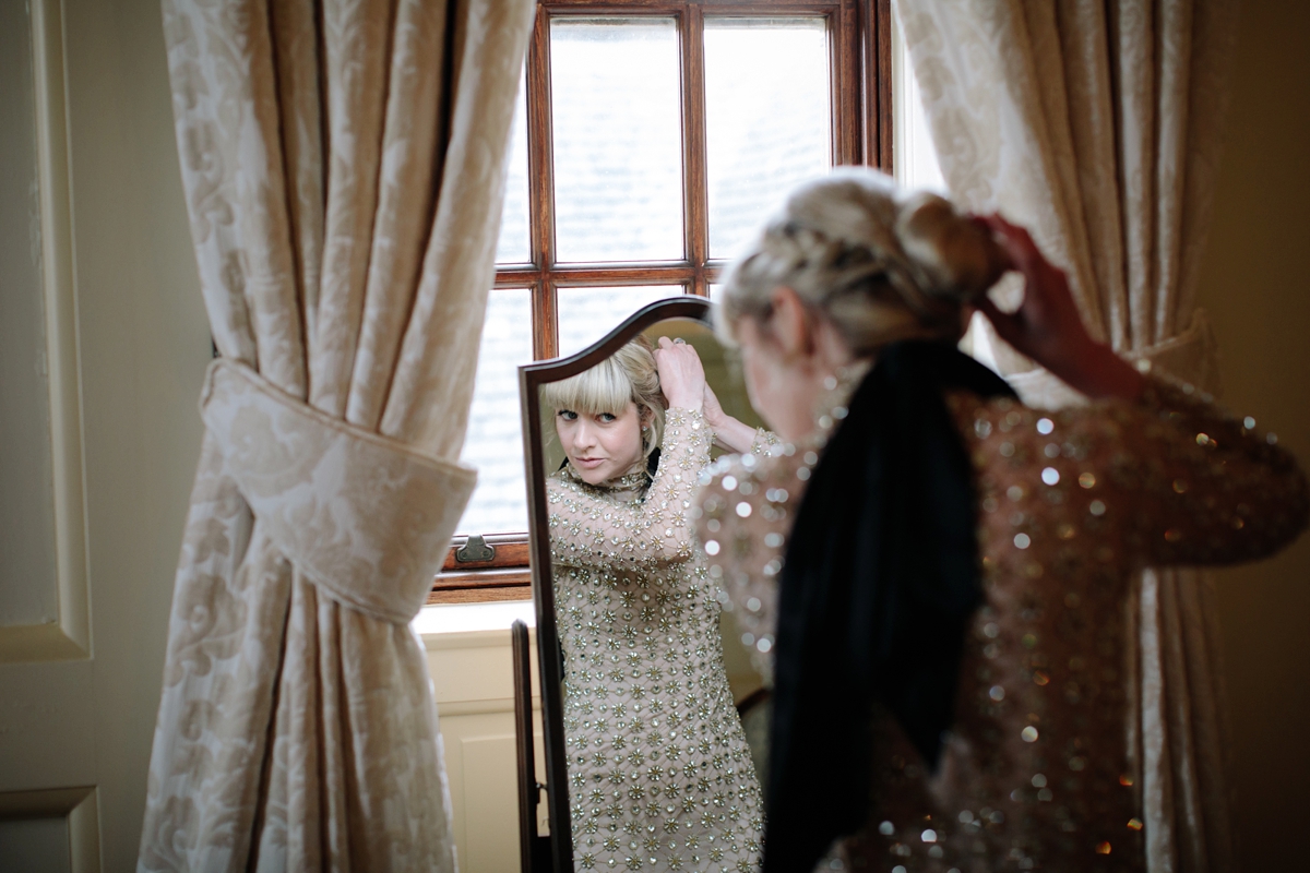 A bride in a gold, embellished Temperley London dress for her wedding at Rowallan Castle in Scotland. Images by Caro Weiss.