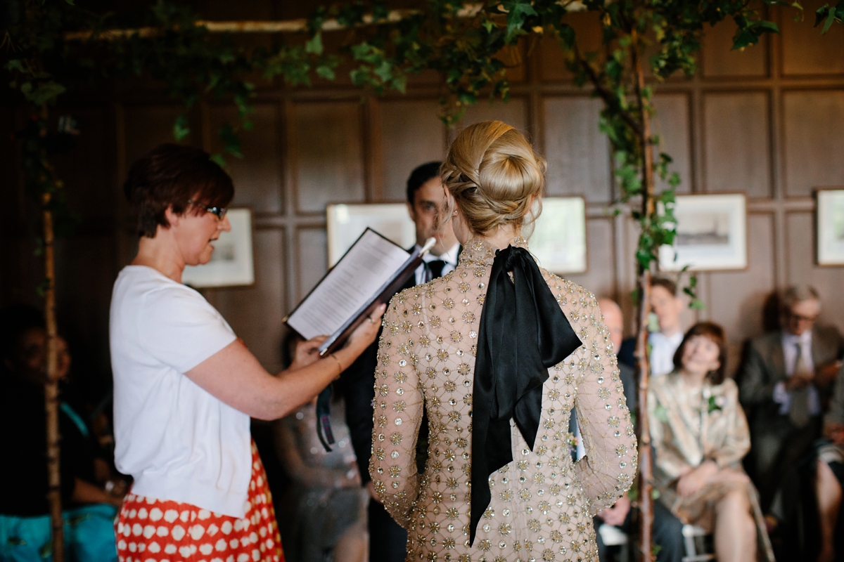 A bride in a gold, embellished Temperley London dress for her wedding at Rowallan Castle in Scotland. Images by Caro Weiss.