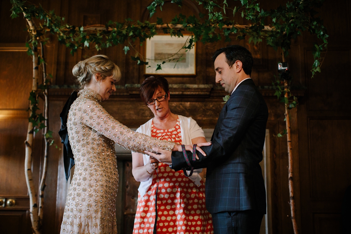 A bride in a gold, embellished Temperley London dress for her wedding at Rowallan Castle in Scotland. Images by Caro Weiss.