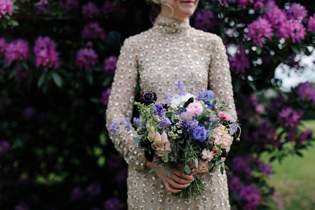 A bride in a gold, embellished Temperley London dress for her wedding at Rowallan Castle in Scotland. Images by Caro Weiss.