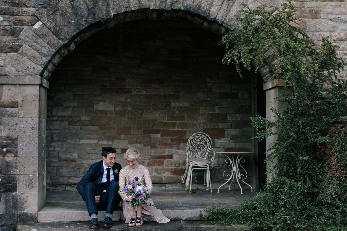 A bride in a gold, embellished Temperley London dress for her wedding at Rowallan Castle in Scotland. Images by Caro Weiss.