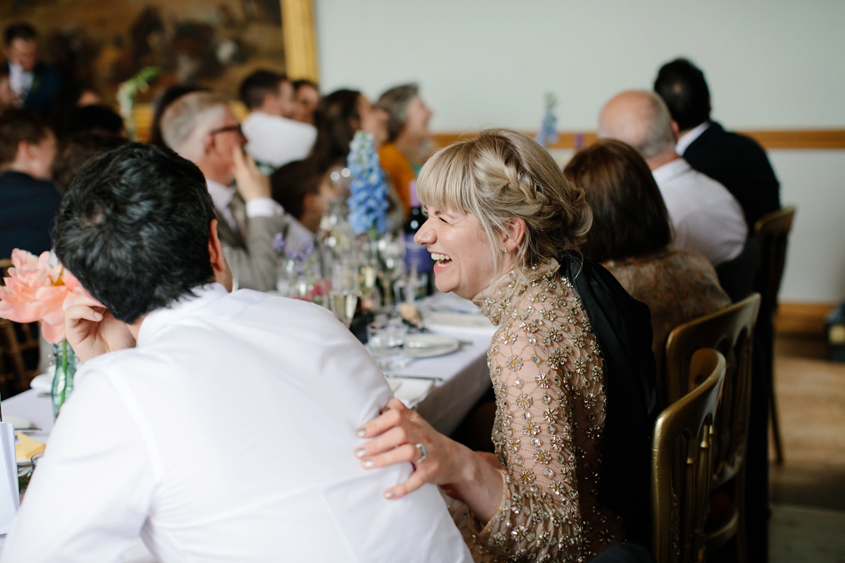 A bride in a gold, embellished Temperley London dress for her wedding at Rowallan Castle in Scotland. Images by Caro Weiss.