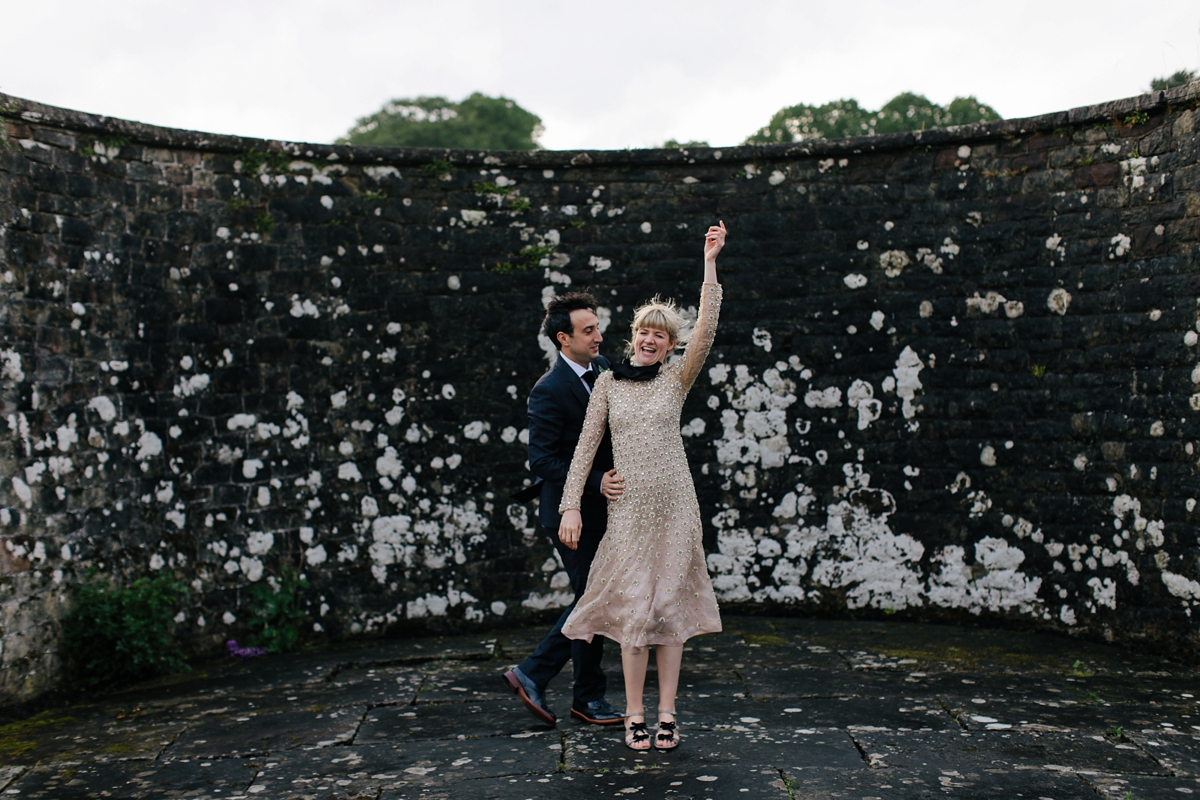 A bride in a gold, embellished Temperley London dress for her wedding at Rowallan Castle in Scotland. Images by Caro Weiss.