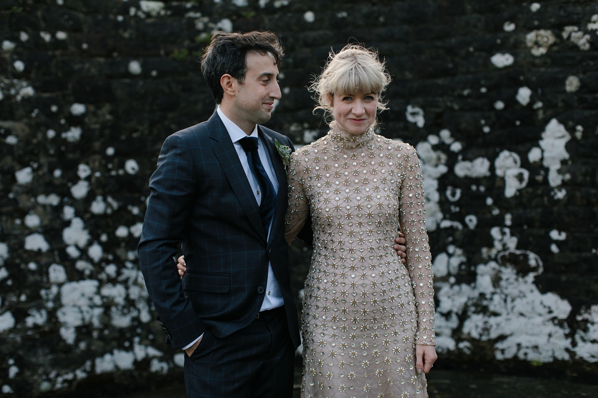 A bride in a gold, embellished Temperley London dress for her wedding at Rowallan Castle in Scotland. Images by Caro Weiss.