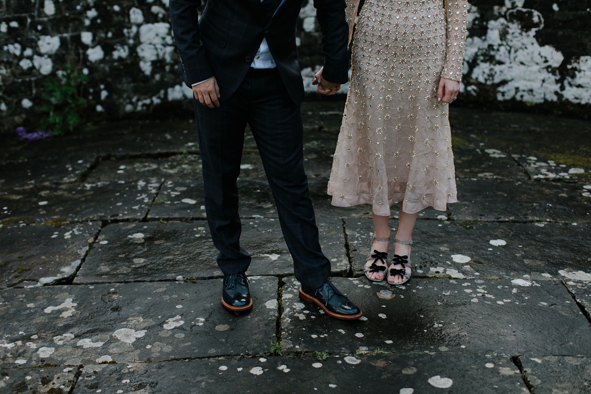 A bride in a gold, embellished Temperley London dress for her wedding at Rowallan Castle in Scotland. Images by Caro Weiss.