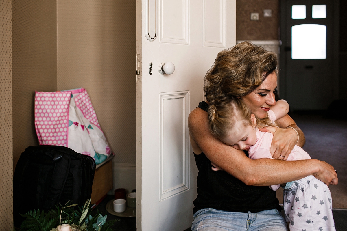 1 Bride embracing her daughter - A Sharon Hoey Dress and French Lace Veil for a Glamorous and Elegant City Wedding 1 Bride embracing her daughter