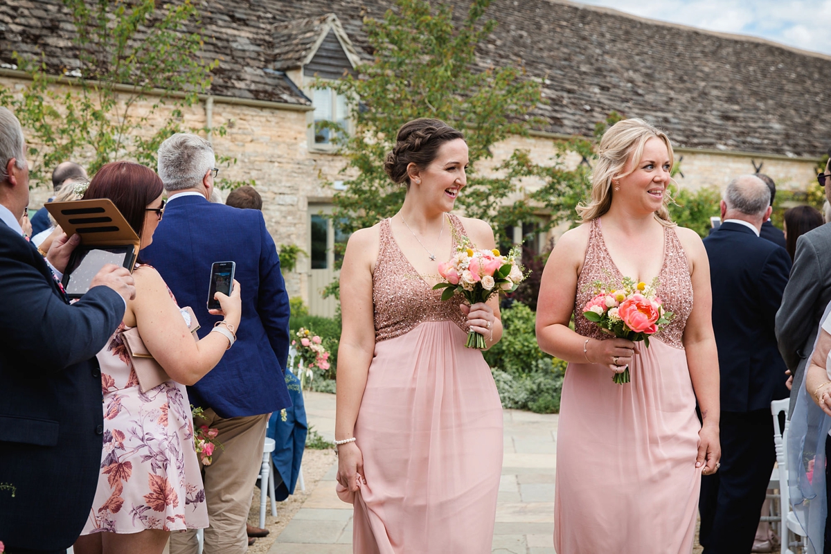 12 Bridesmaids in sandy pink halterneck dresses from Monsoon 1