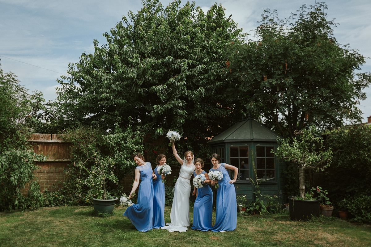 13 Bridesmaids in cornflower blue dresses from Monsoon