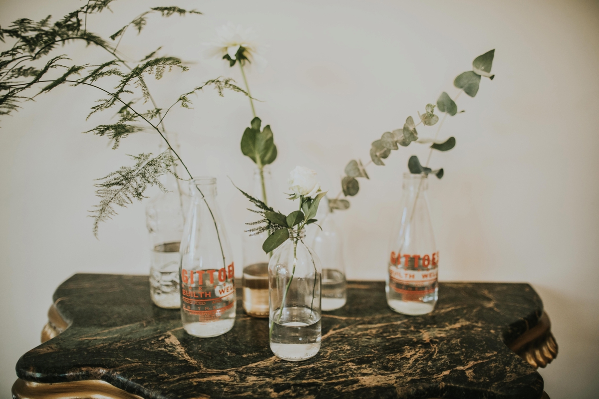 14 Single stem flowers in glass bottles