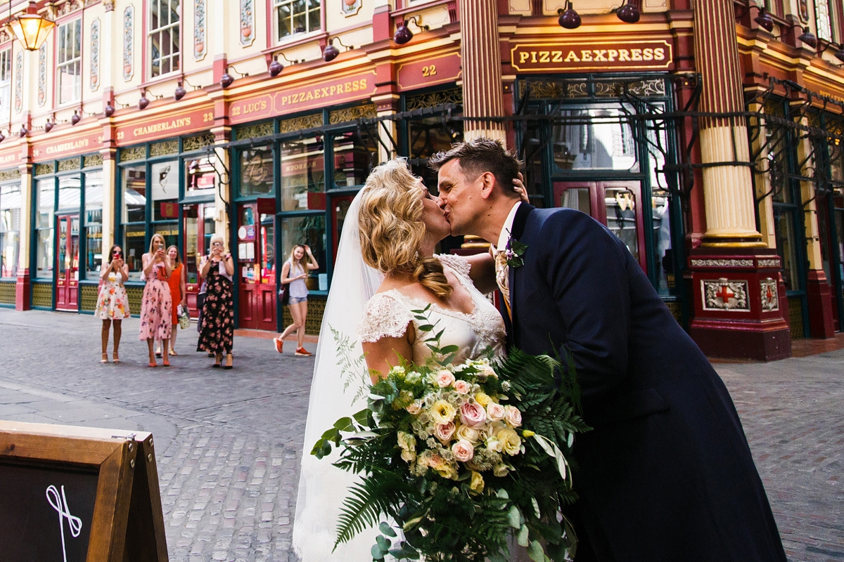 17 Bride and groom in a romantic kissing embrace - A Sharon Hoey Dress and French Lace Veil for a Glamorous and Elegant City Wedding 17 Bride and groom in a romantic kissing embrace