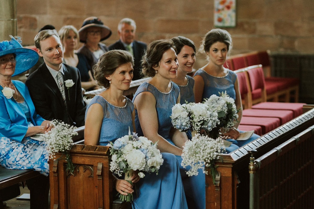 22 Bridesmaids wearing cornflower blue dresses from Monsoon