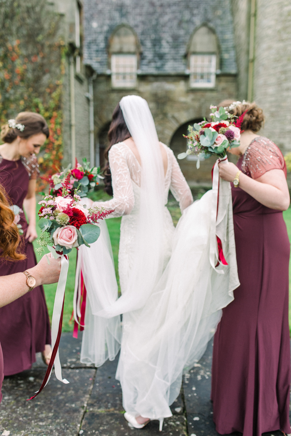 23 Bride in Rosa Clara carrying a large red and pink Autumn wedding bouquet