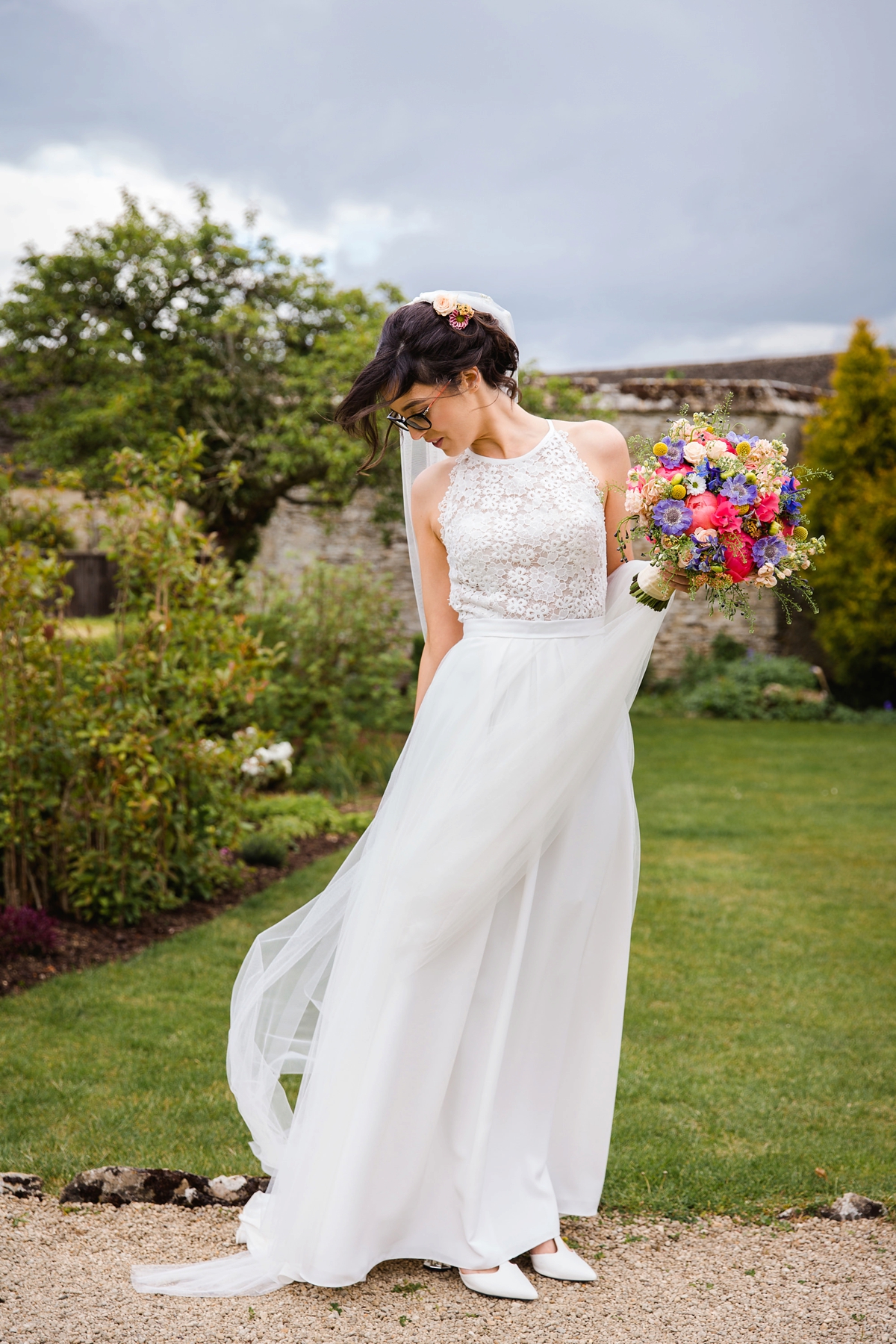 25 Bride in glasses carrying a colourful summer bouquet 1