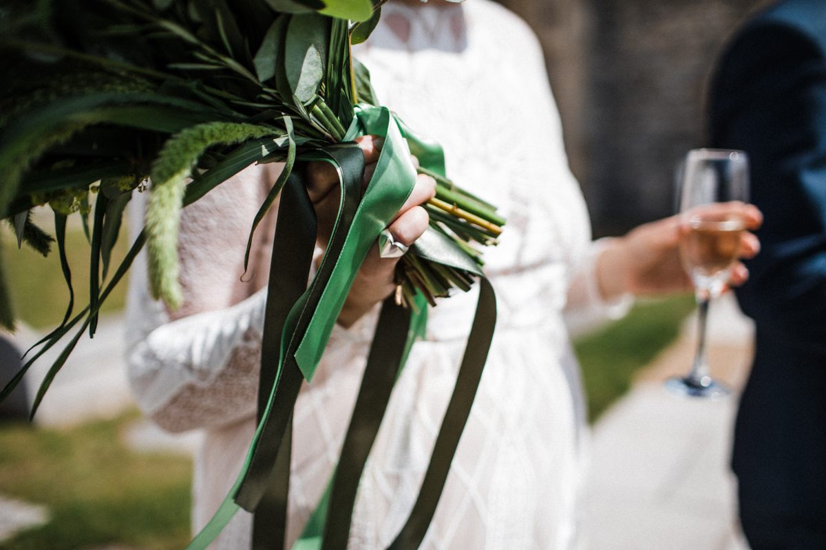 26 Close up of bride holding an all green wedding bouquet