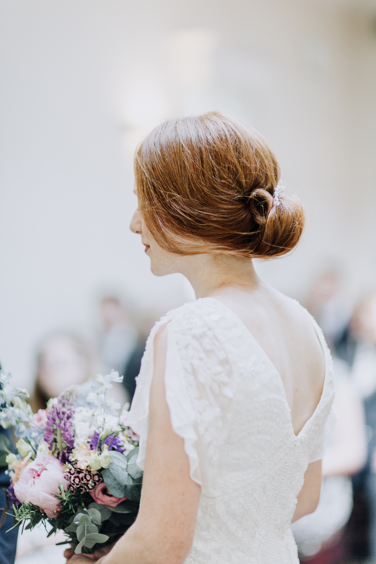 26 Red haired bride wearing an elegant low bun up do