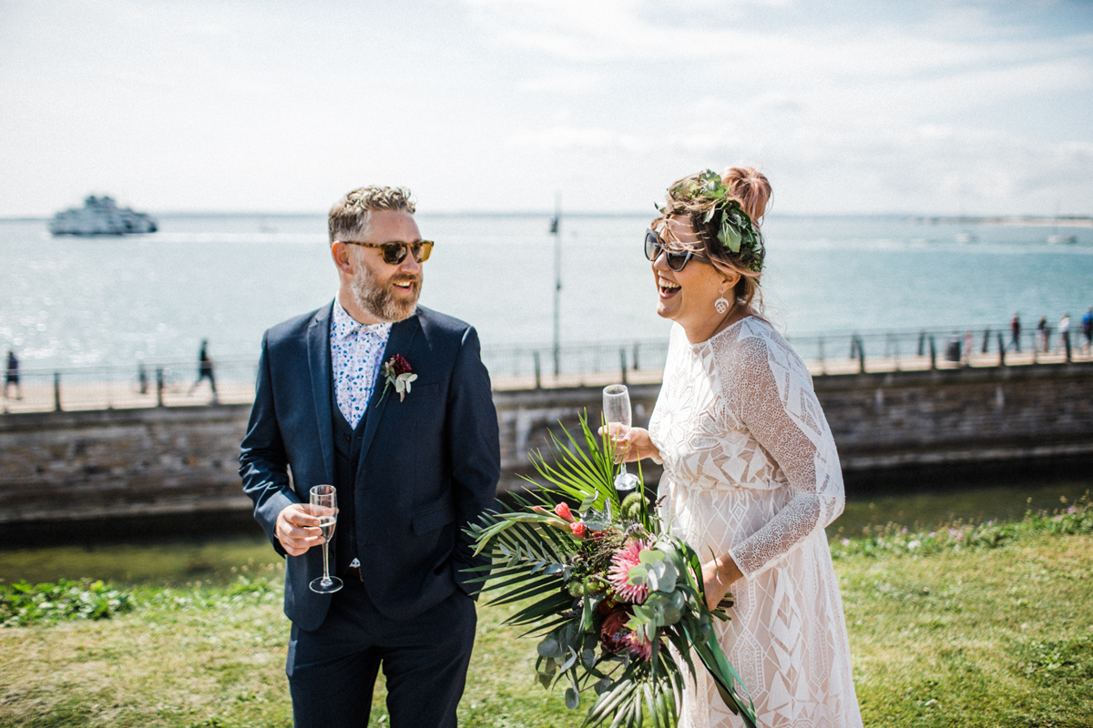28 Modern boho bride and groom laughing by the sea