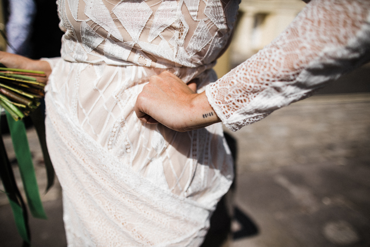 29 Bride with small wrist tattoo wearing Grace Loves Lace