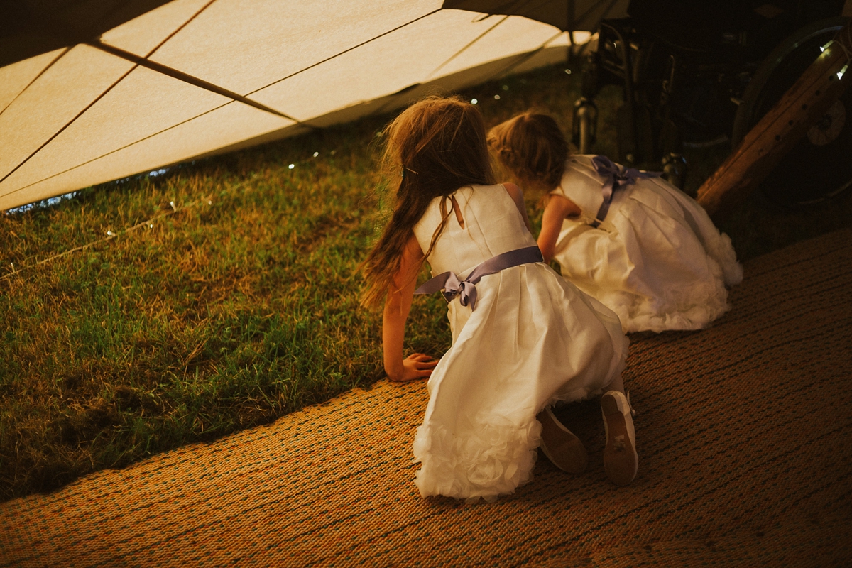 31 Little girls peeping out of a wedding tipi