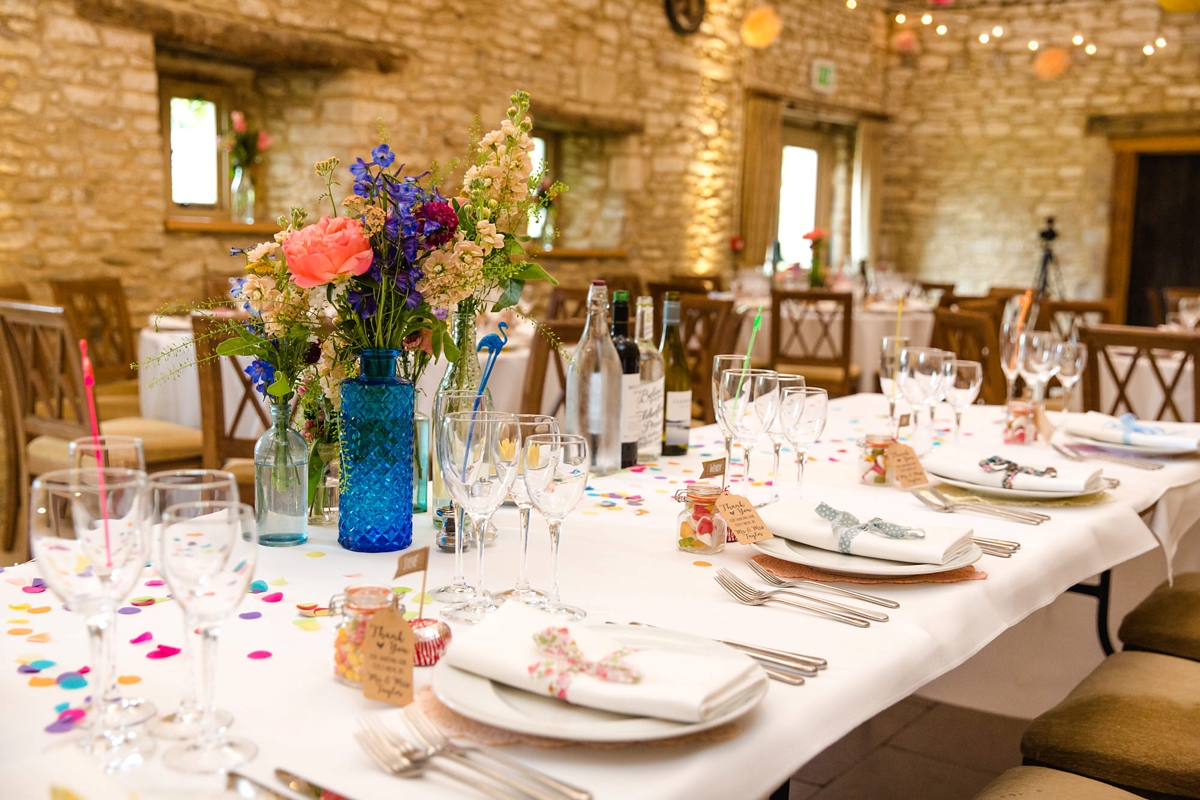 33 Barn wedding with colourful floral table centrepieces 1