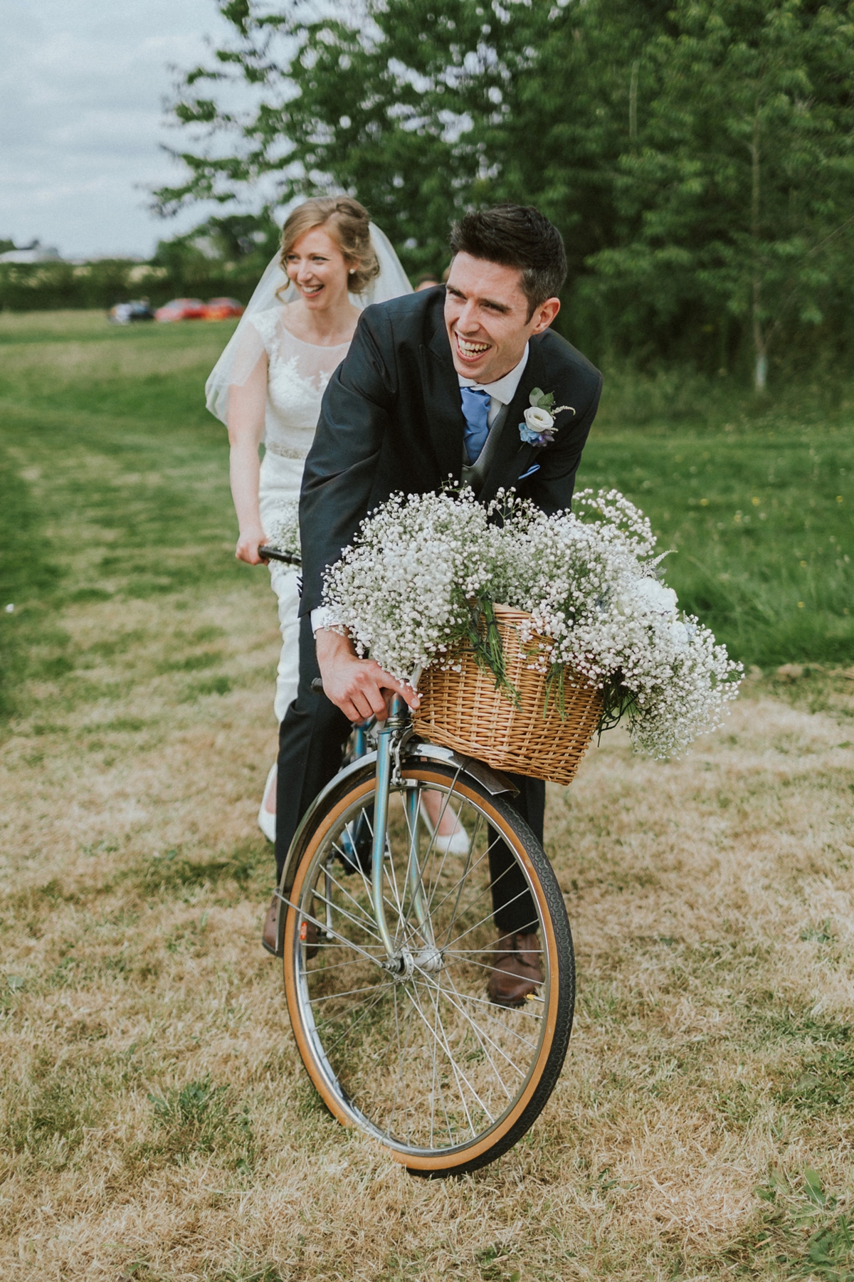 4 Newlywed couple riding a tandem bicycle