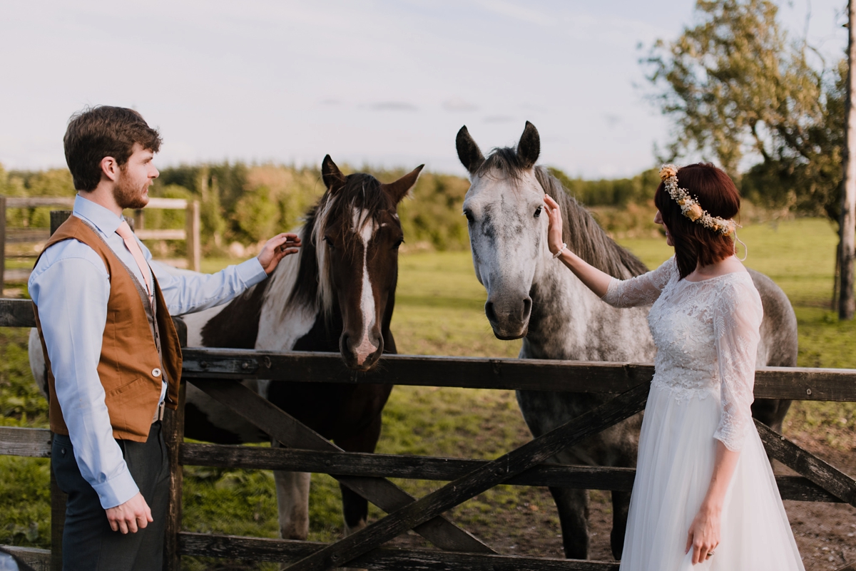 41 Bride and groom stroking horses