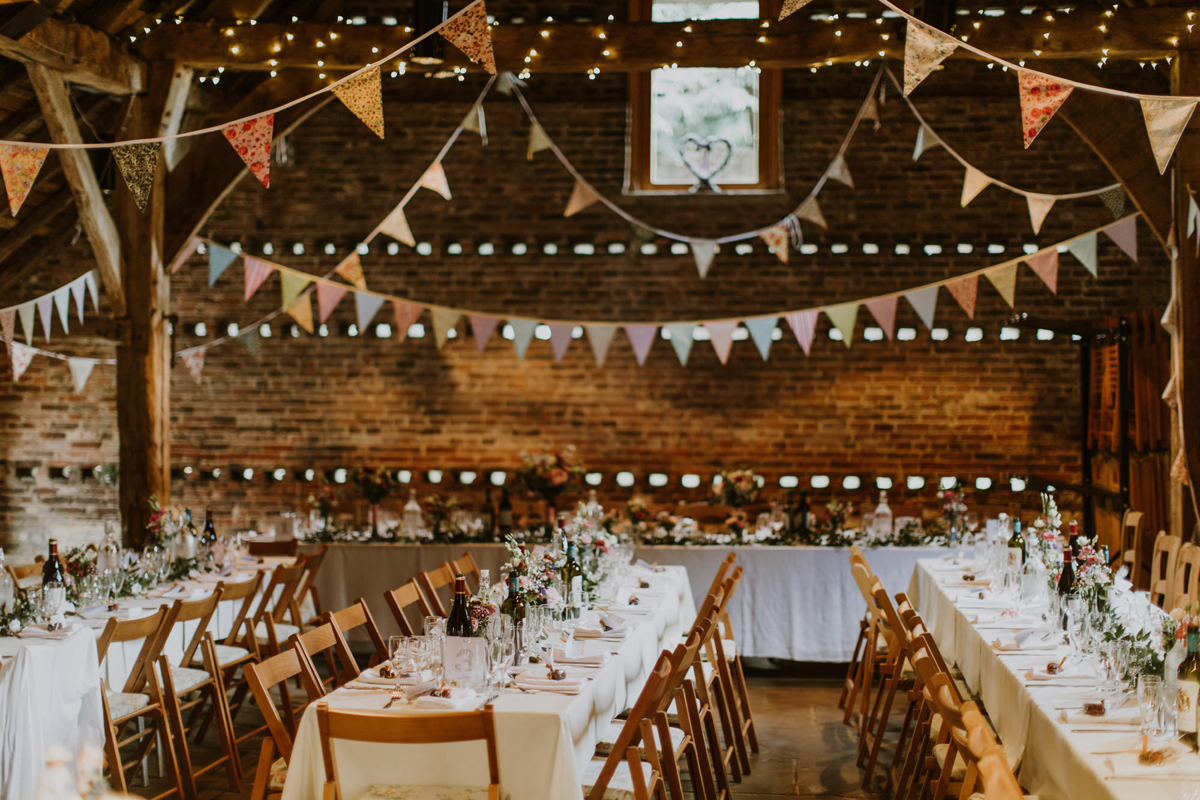43 Poppleton Tithe Barn wedding venue tressel tables and bunting reception