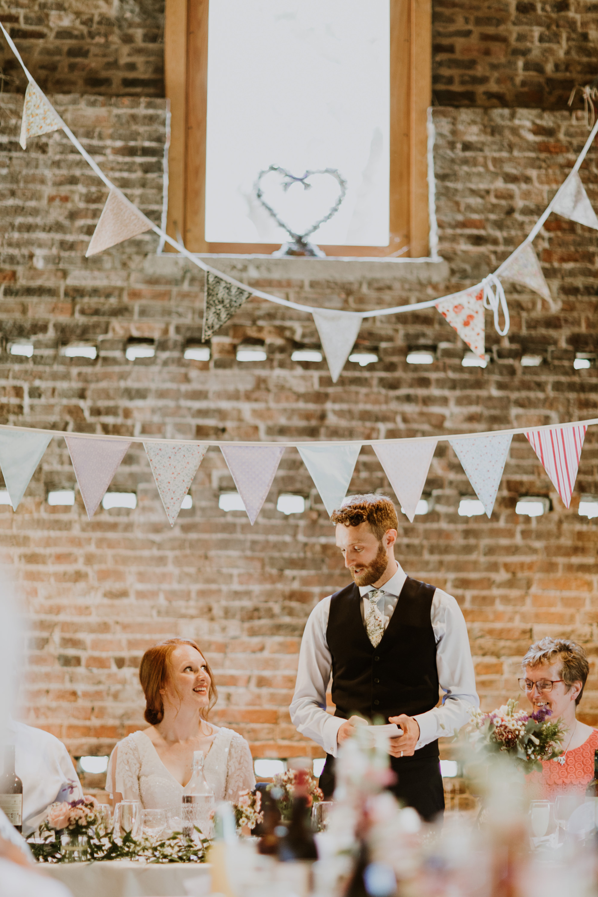 60 Groom giving a speech to his bride in a barn wedding venue