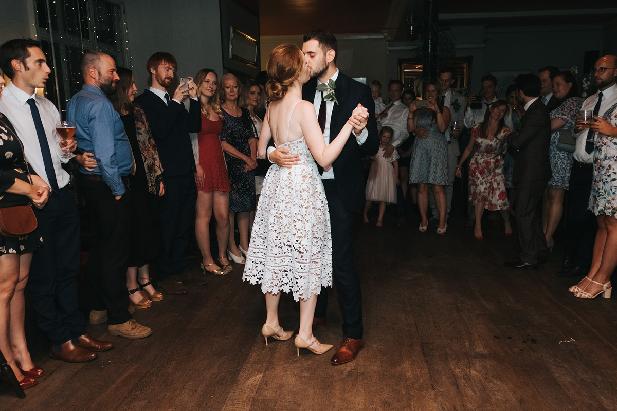 Bride and groom first dance at a laidback and intimate London wedding bride wears Self Portrait