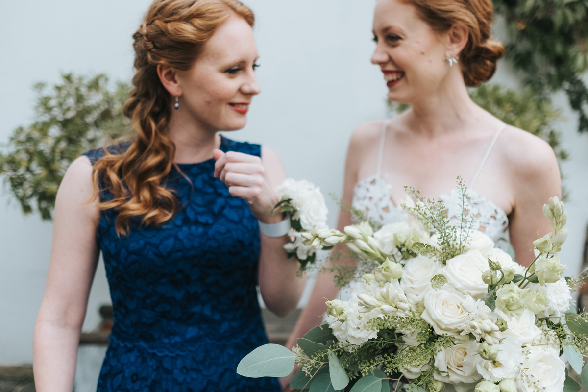 Bride in Self Portrait and her bridesmaids in a blue dress