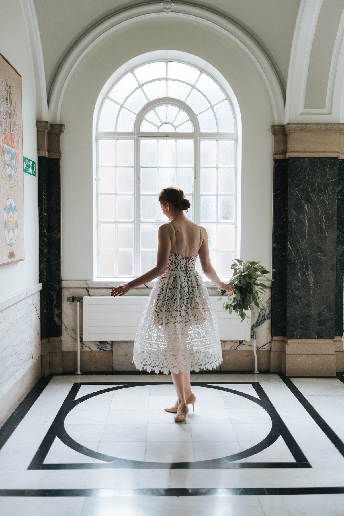 Bride standing in natural window light at Islington Town Hall