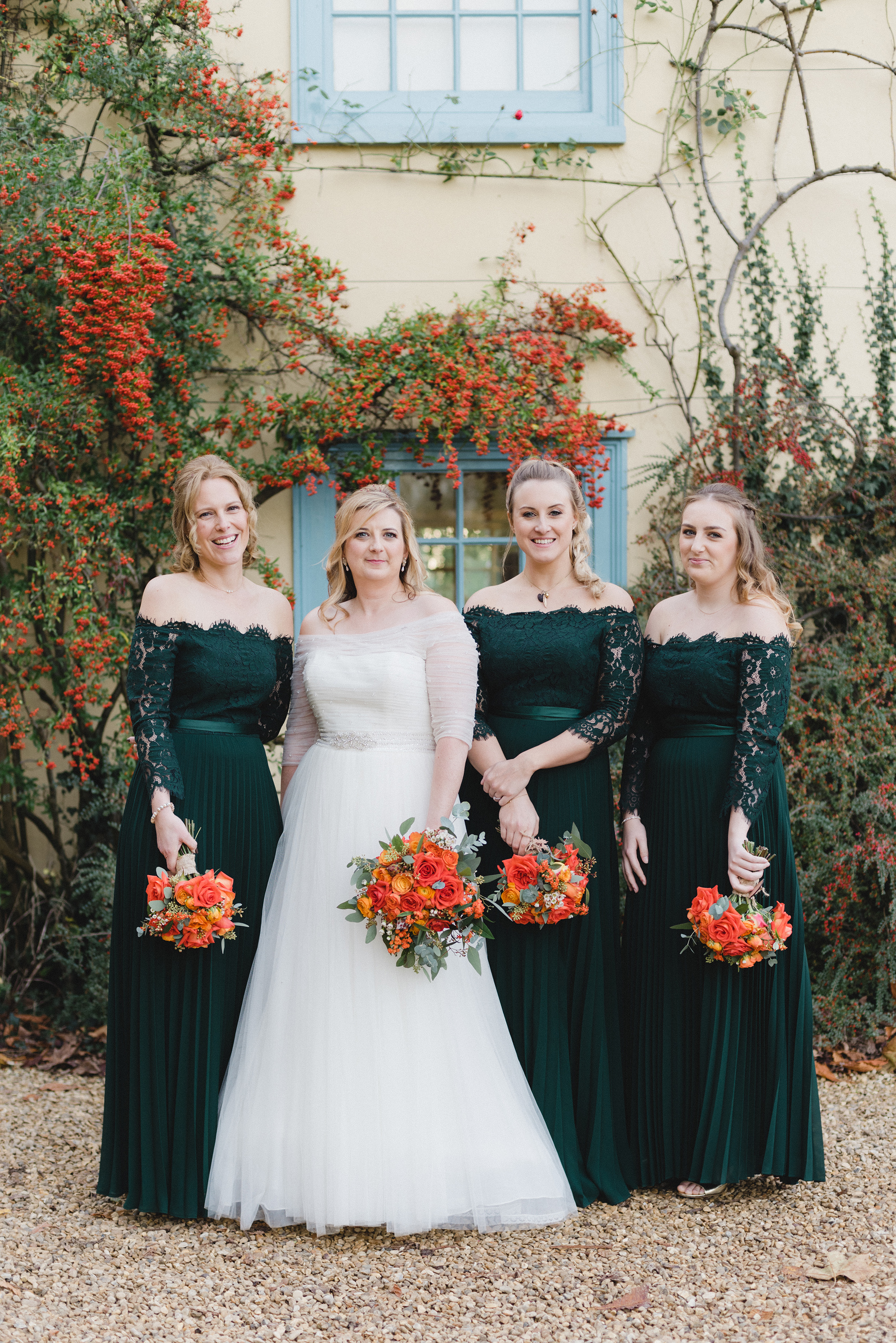 Bride wearing La Sposa and maids in bottle green Coast pleated dresses