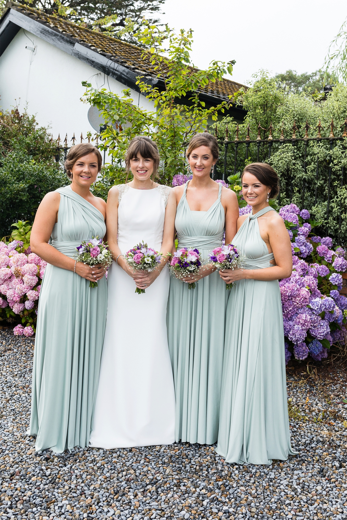 Bride wearing Pronovias and her maids in sage green dresses