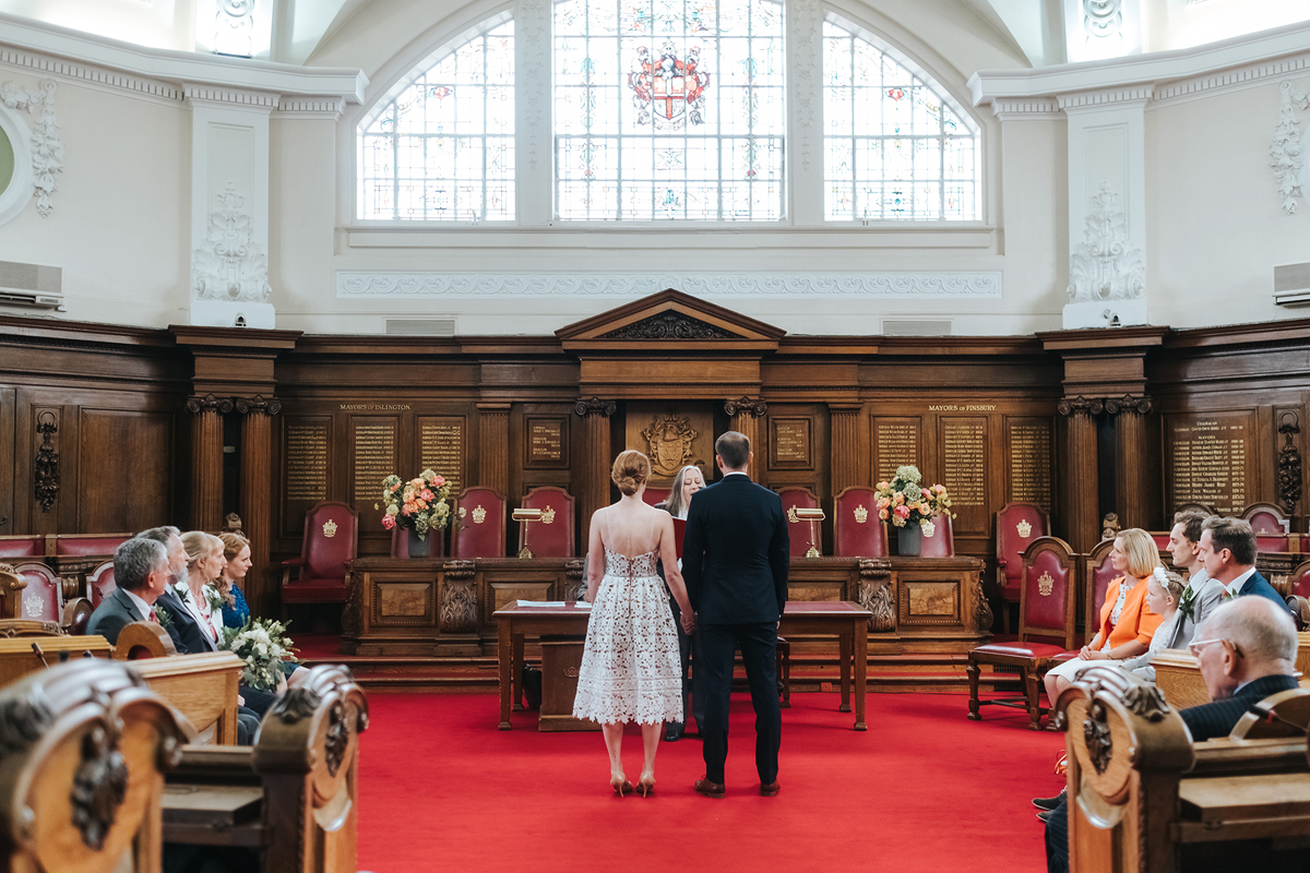 Couple standing on a red carpet at Islington Town Hall