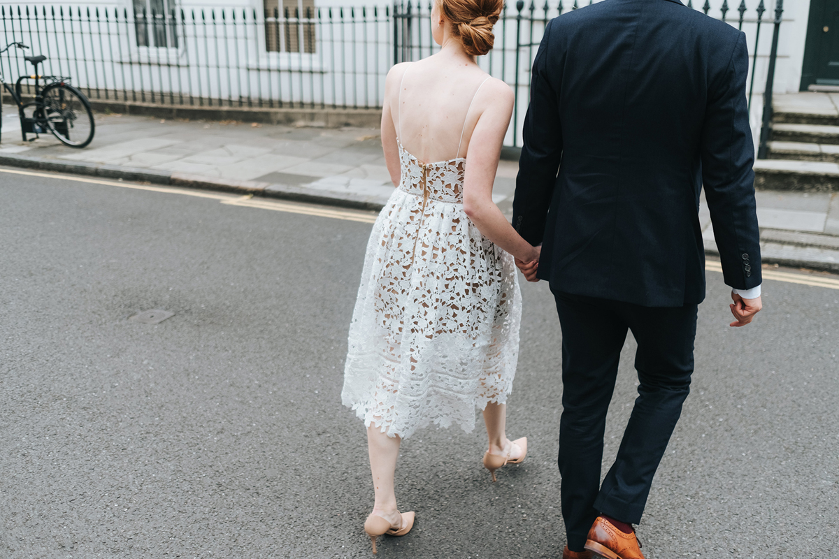 Modern bride and groom crossing the road in London