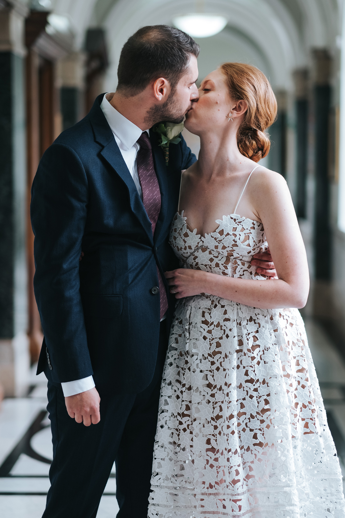 Modern newlywed couple embrace after getting married