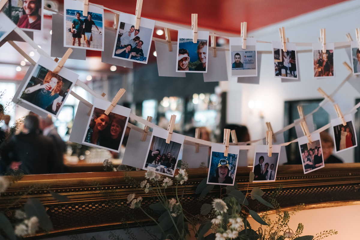 Polaroid photographs pegged to string for a pretty wedding decoration