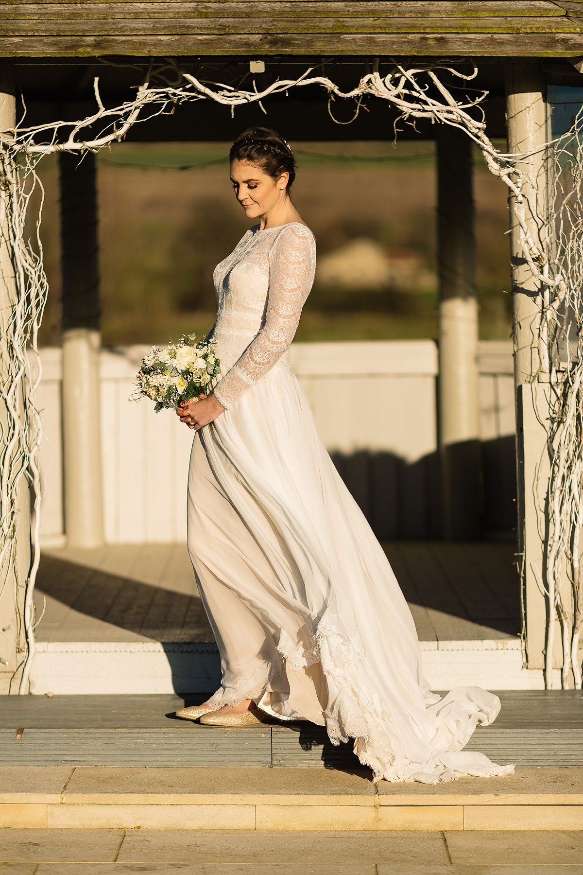 21 A Long sleeved Maggie Sottero dress for a candle lit winter barn wedding
