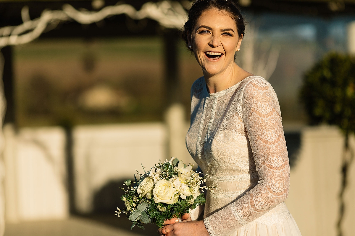 24 A Long sleeved Maggie Sottero dress for a candle lit winter barn wedding