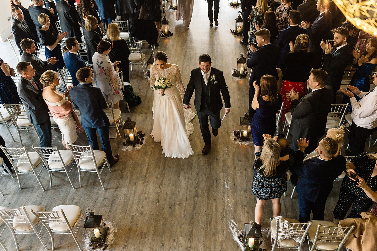 28 A Long sleeved Maggie Sottero dress for a candle lit winter barn wedding