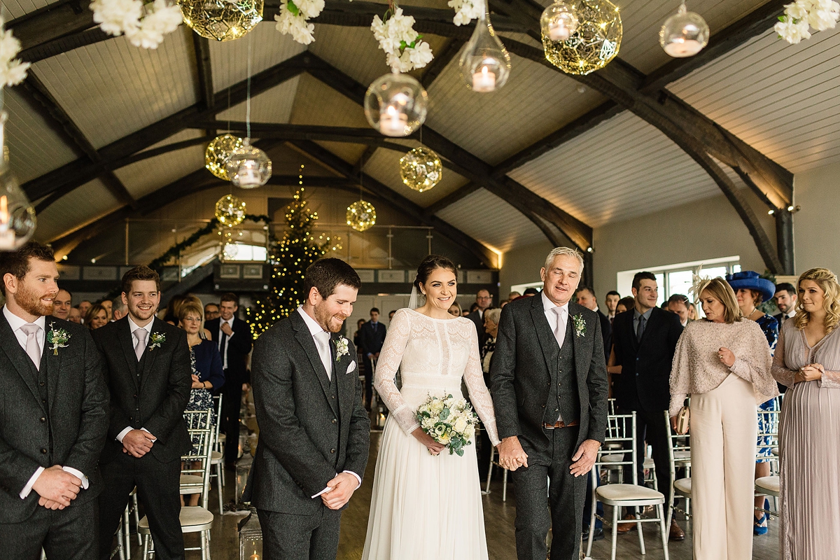 35 A Long sleeved Maggie Sottero dress for a candle lit winter barn wedding