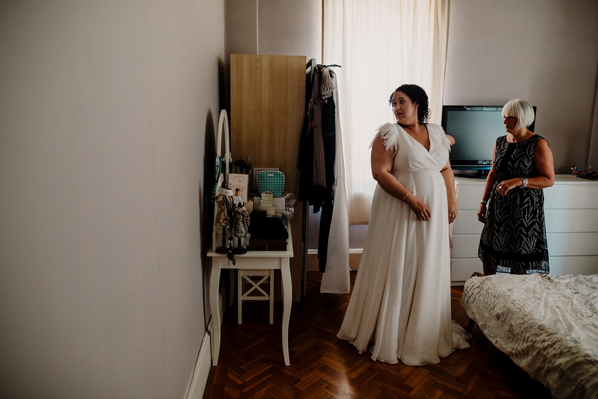 11 A pregnant bride wearing a feather cap sleeved Halfpenny London dress