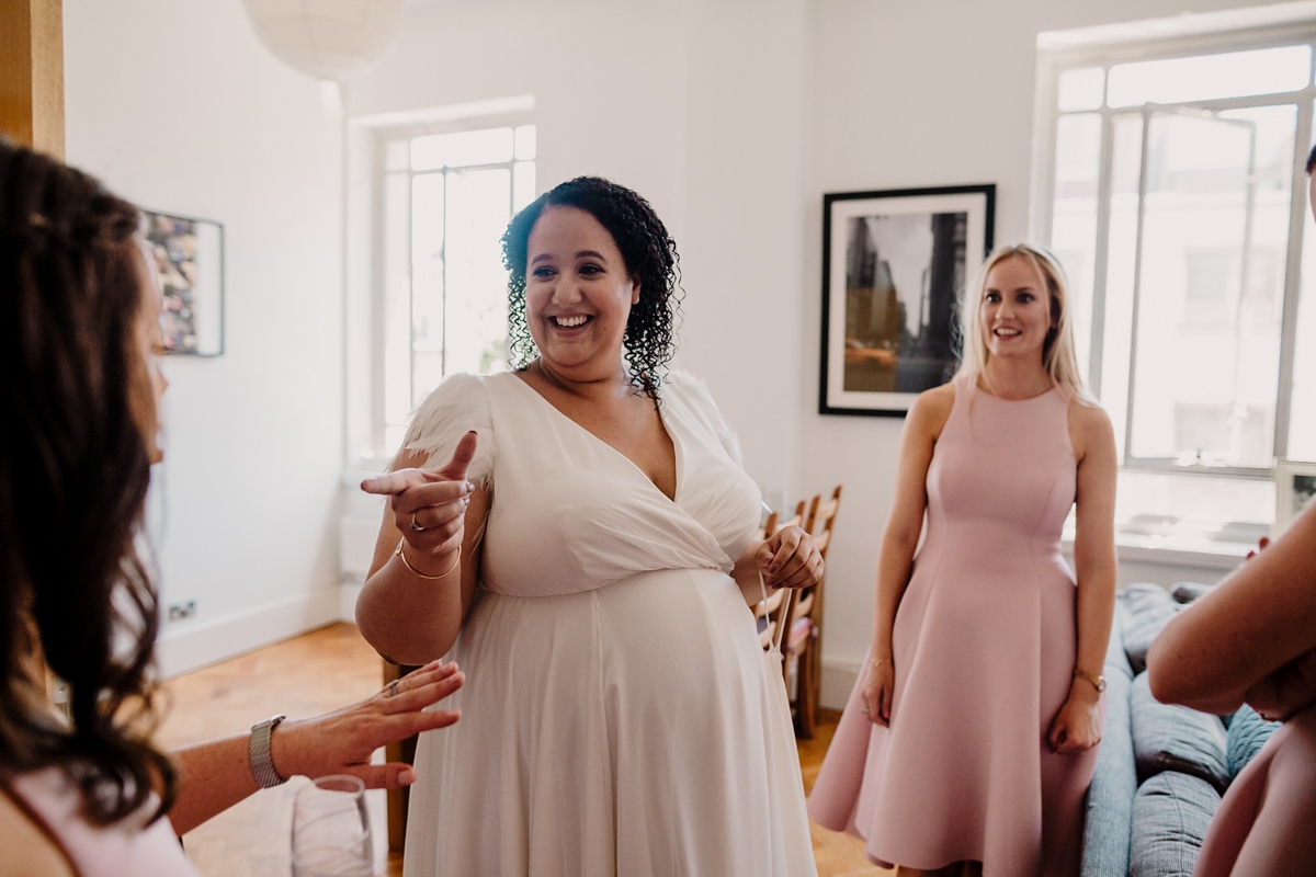 12 A pregnant bride wearing a feather cap sleeved Halfpenny London dress