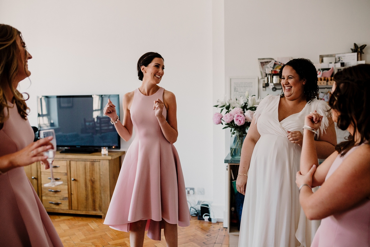 13 A pregnant bride wearing a feather cap sleeved Halfpenny London dress