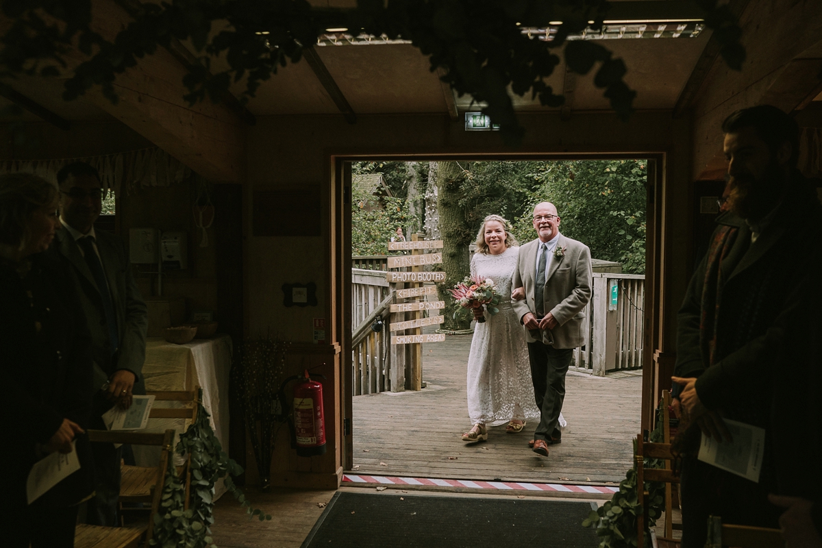 15 A bride wearing a Moonsoon dress for her treetop Autumn wedding