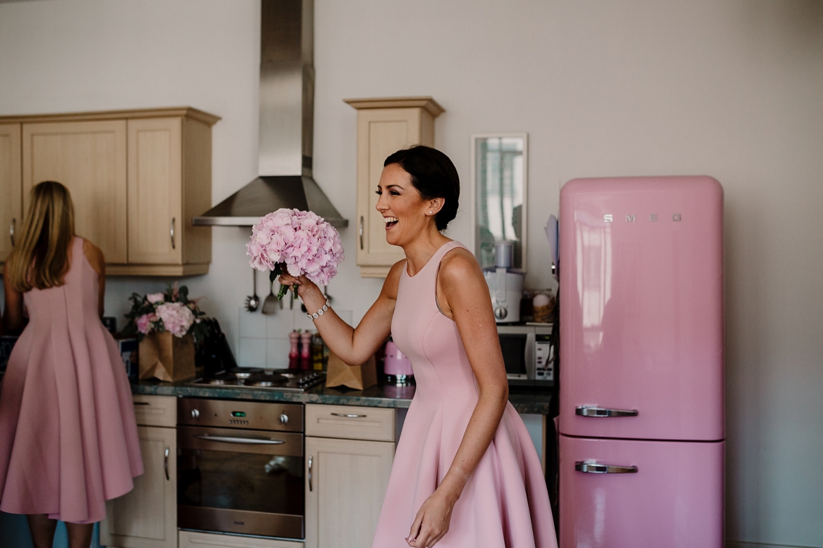 15 A pregnant bride wearing a feather cap sleeved Halfpenny London dress