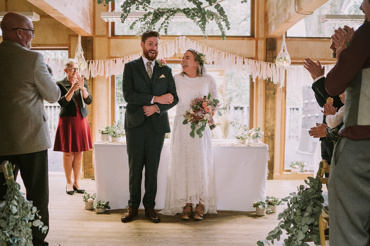 16 A bride wearing a Moonsoon dress for her treetop Autumn wedding