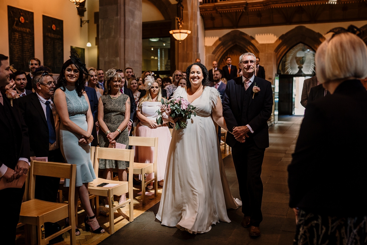 22 A pregnant bride wearing a feather cap sleeved Halfpenny London dress