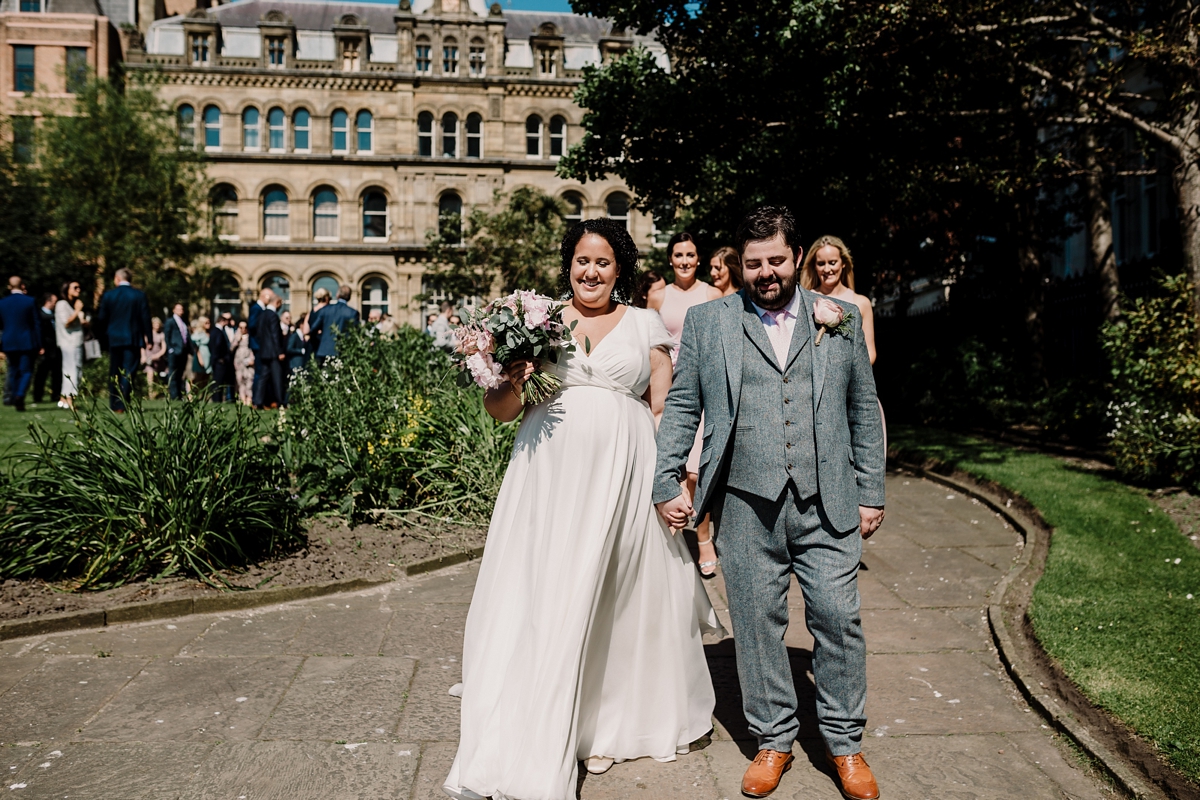 26 A pregnant bride wearing a feather cap sleeved Halfpenny London dress